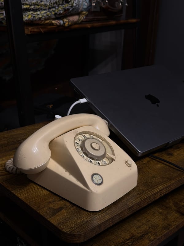 Vintage rotary phone photographed beside modern laptop in Russia