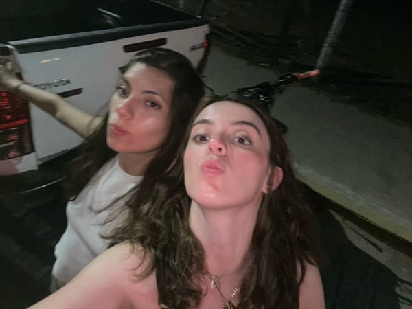 Two women stand by taxi in Brisas de Zicatela