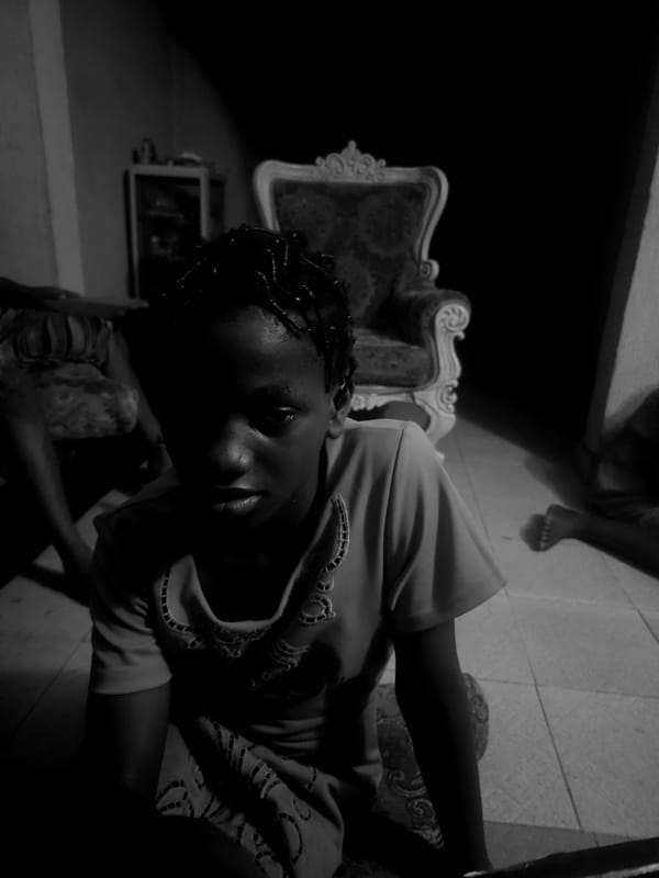 Person photographed in dimly lit indoor scene