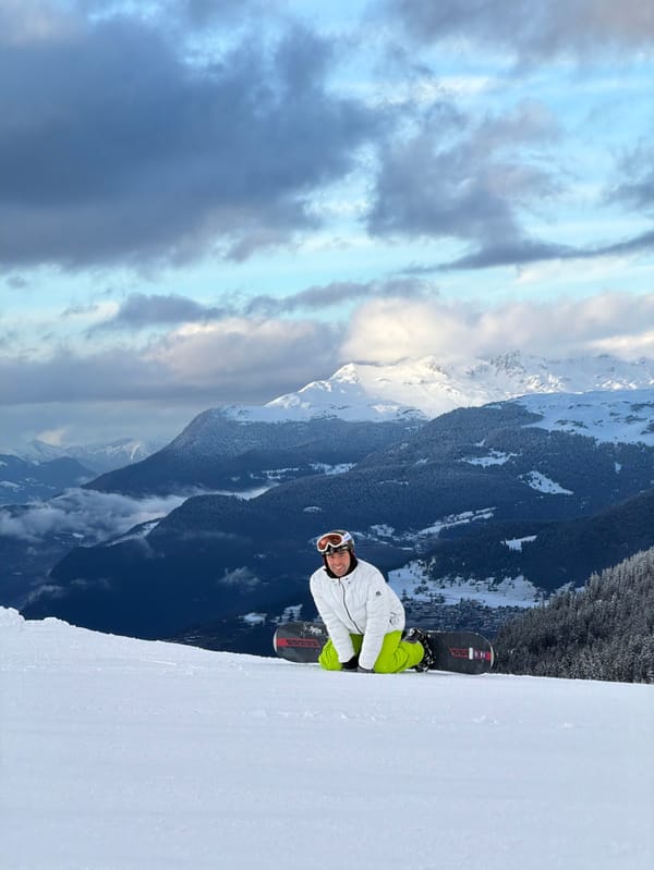 Snowboarder pauses on slopes in Les Allues, France