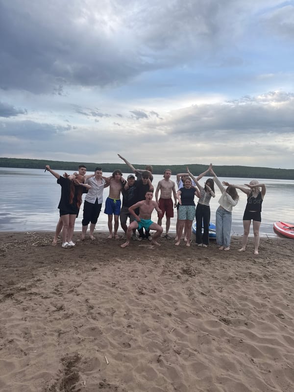 Beach gathering features human formations and wrestling in Chaikovsky