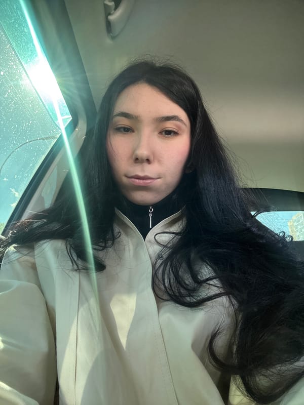 Woman photographed in car during sunny morning in Naberezhnye Chelny