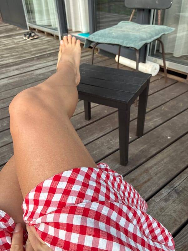 Relaxing on a deck near pink roadside buildings in Arkhipo-Osipovka