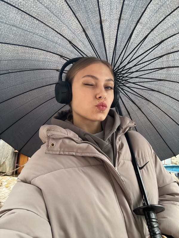 Woman poses playfully with umbrella in early morning Russia