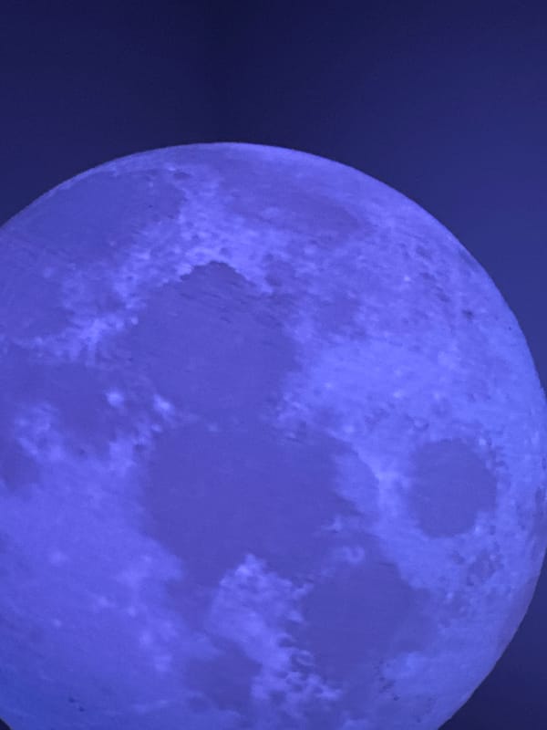 Late-night moon photography session over Lübeck rooftops