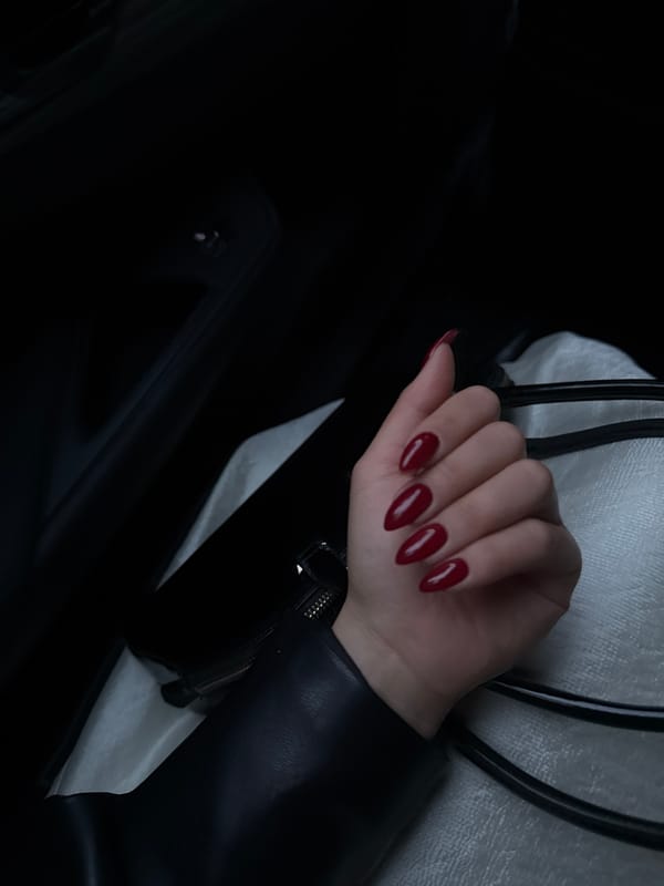 Hand with red nails photographed in vehicle, Yerevan