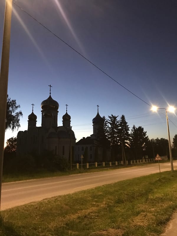 Orthodox church with blue domes photographed at dusk in Lanivtsi