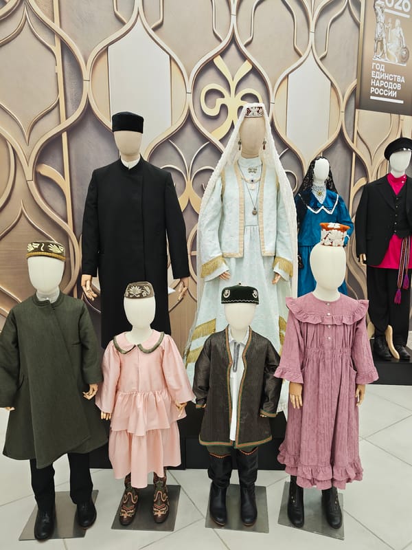 Folk costumes, samovars, and crowds at a cultural exhibition