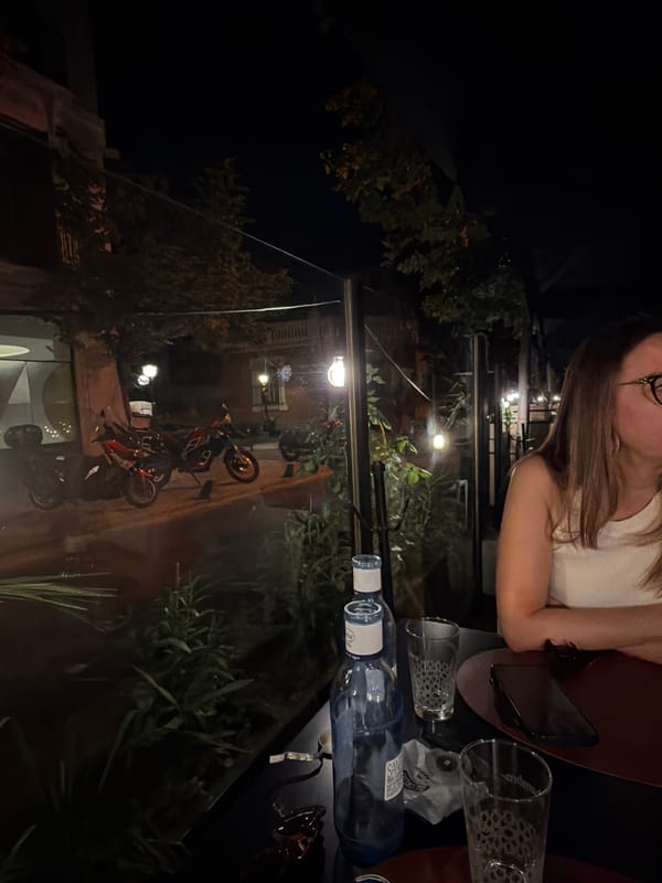 Woman dines at nighttime outdoor restaurant patio