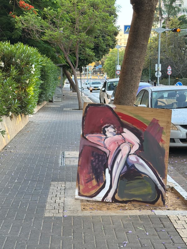 Large reclining figure painting rests on a Tel Aviv sidewalk