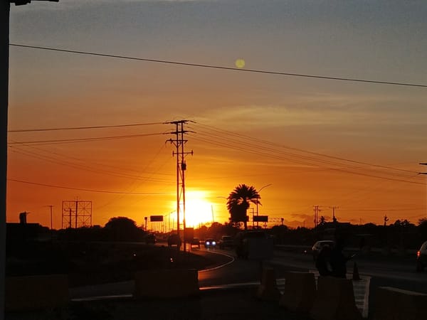 Sunset captured across Venezuelan towns with cats resting nearby