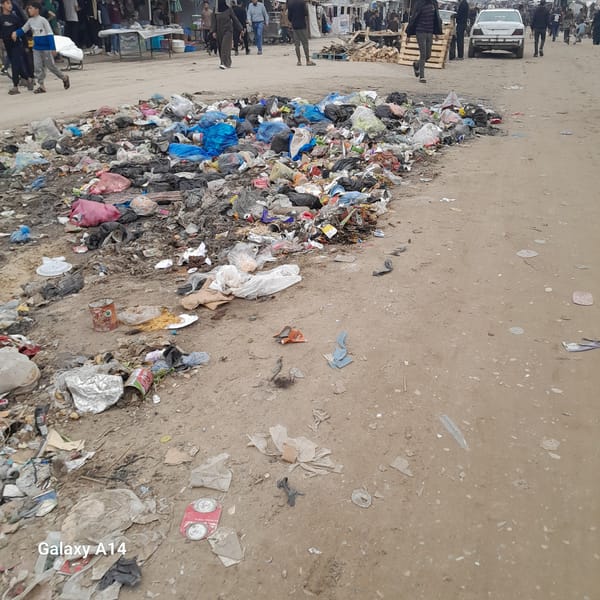 Pedestrians navigate trash-strewn streets in Khan Yunis