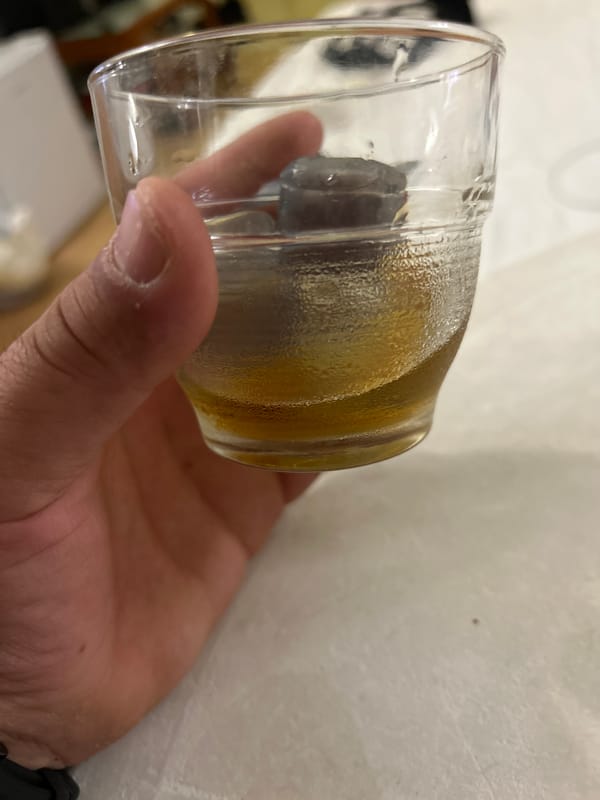Person holds iced amber drink in Sveti Vlas, Bulgaria