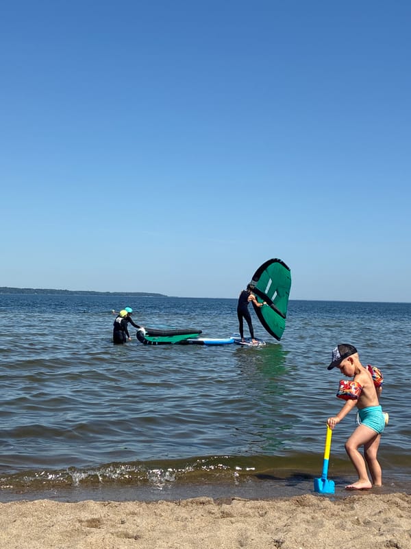 Busy summer morning at Rewa beach: water sports and shoreside relaxing