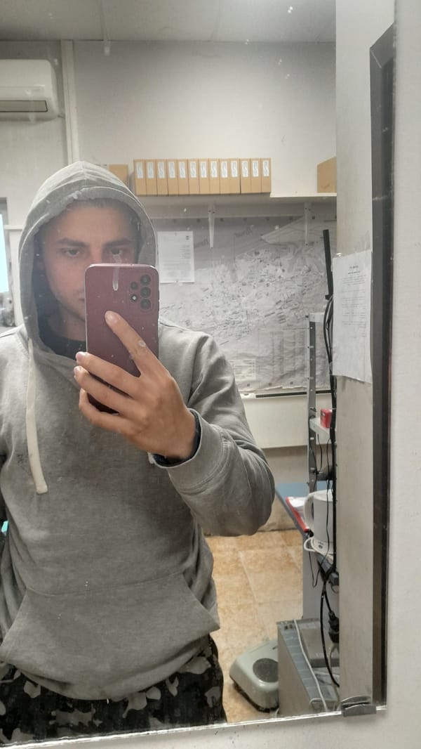 Person takes mirror selfie in gray hoodie in Svishtov