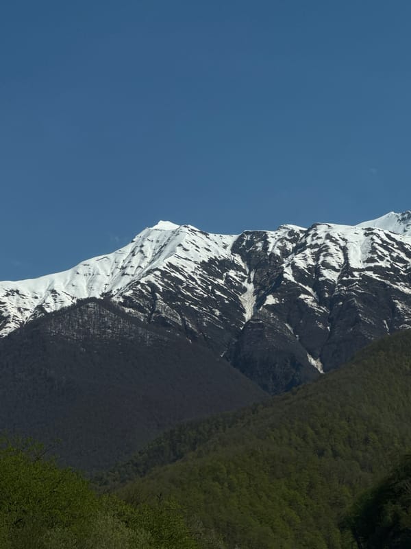 Snow-covered mountains observed under blue skies in Estosadok, Russia