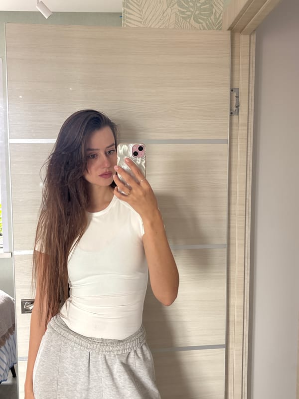 Woman takes morning selfies, applies makeup in Krasnoyarsk apartment