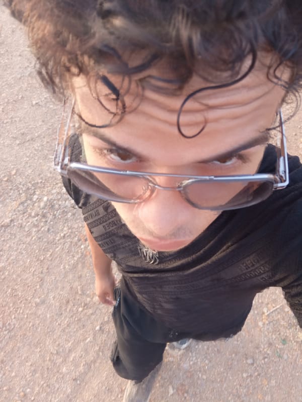 Young man takes selfies during sunset in Juan Griego