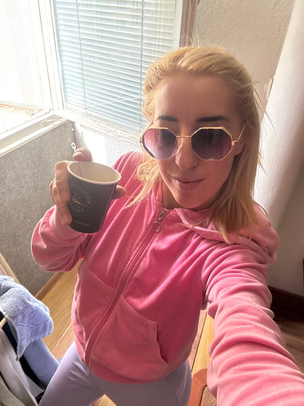 Morning moments in Sofia: Woman with coffee, puppy receives pets