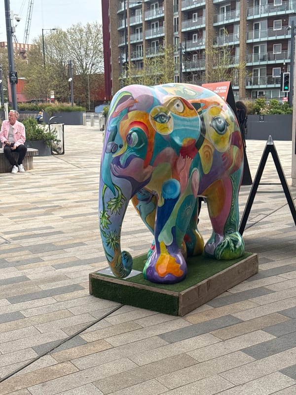 London park scene captured: elephant art, food truck, coffee