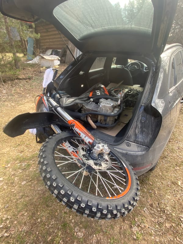 Dirt bike loaded into Audi hatchback in Belarus