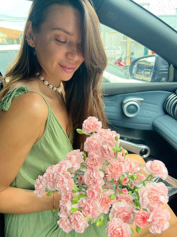 Woman buys flowers, visits convenience store in Thailand morning