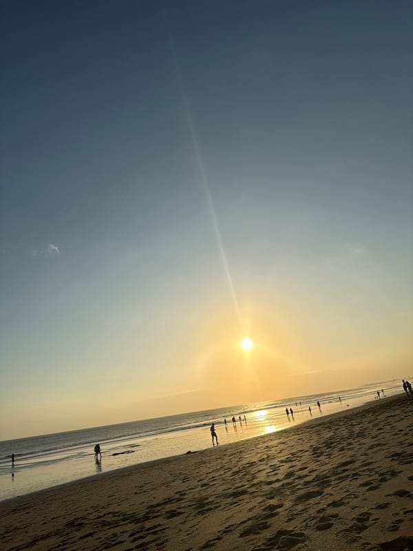 Bali's North Kuta beach at golden hour, live music nearby
