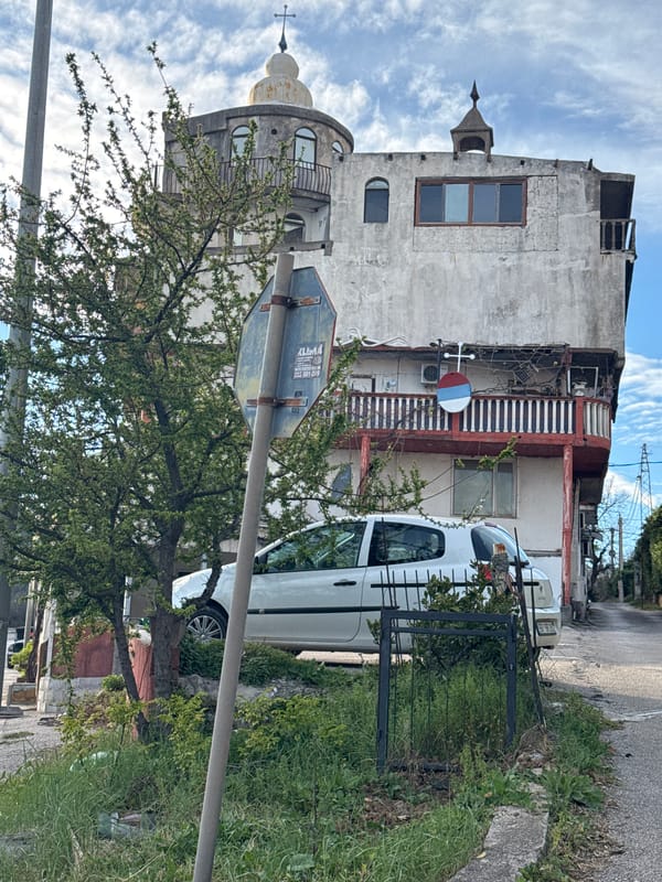 Aged three-story building documented in Zgrade, Montenegro street scene