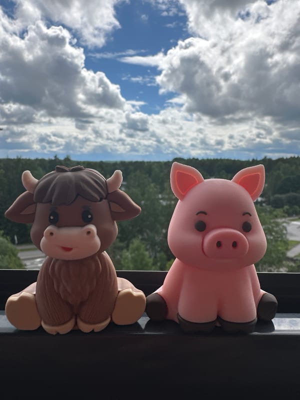 Tiny farm animal figurines photographed outdoors in playful detail