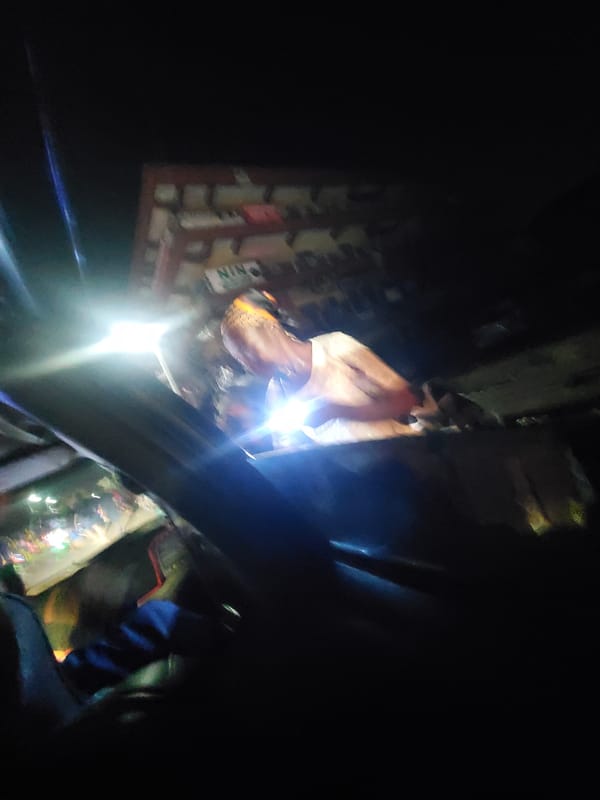 Man illuminated by bright light inside vehicle in Fegge
