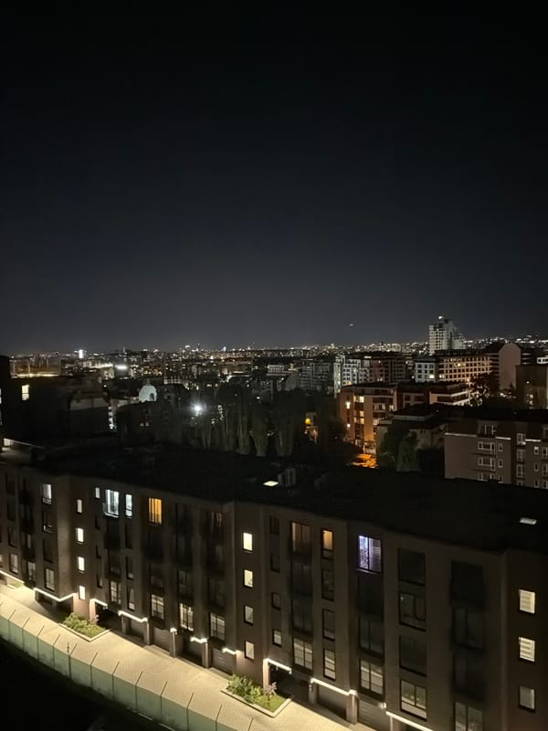 Sofia's nighttime skyline glowing across a dense urban grid
