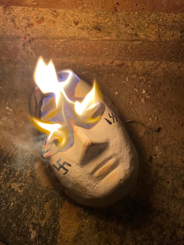 Masked individual burns symbol-marked masks across Plovdiv's historic sites