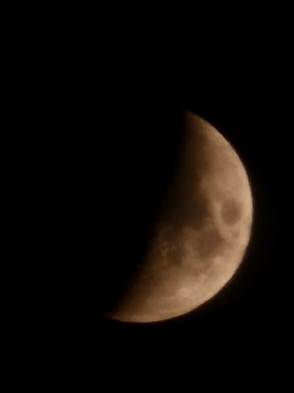 Partial moon observed with visible craters in Kalinovka, Russia
