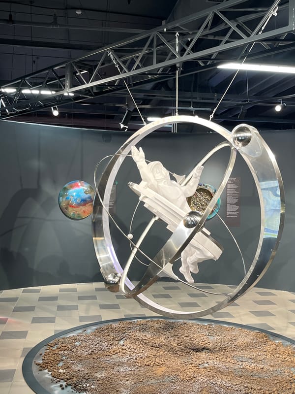 Museum exhibit features astronomical sculpture and dandelion-shaped light fixtures