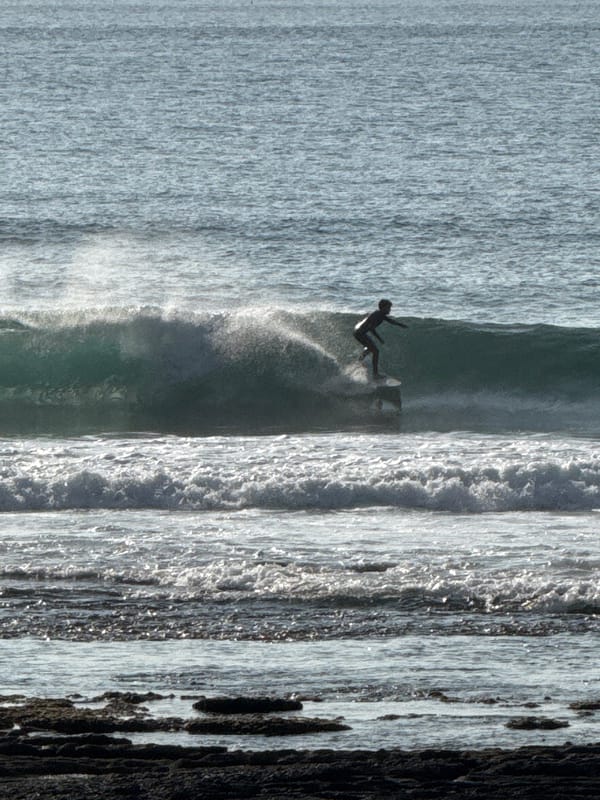 Surfers and beachgoers on Tenerife's south coast