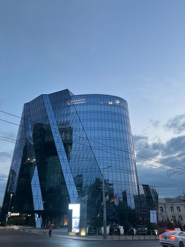 Dusk settles over a glass skyscraper in central Chișinău