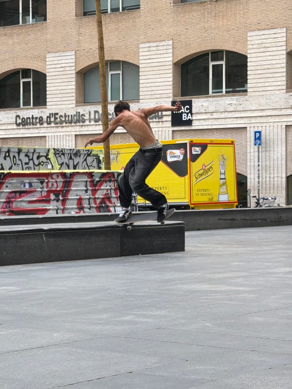Skateboarders perform tricks at Barcelona plaza during midday session