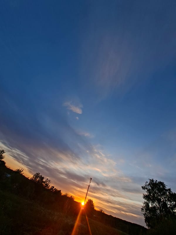 Sunset observed with communication tower silhouette captured by witness