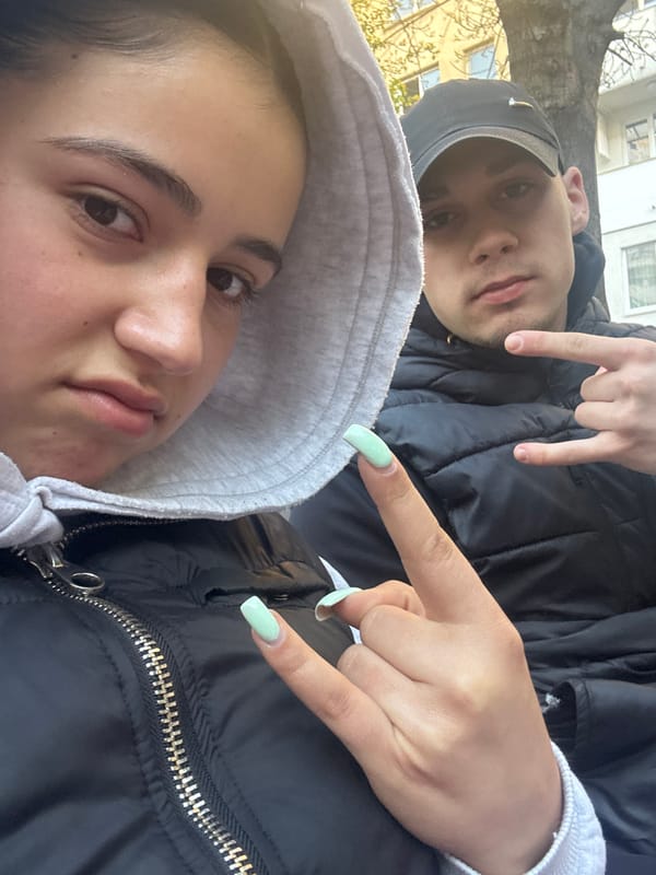 Two young people photographed together outdoors in daytime selfie