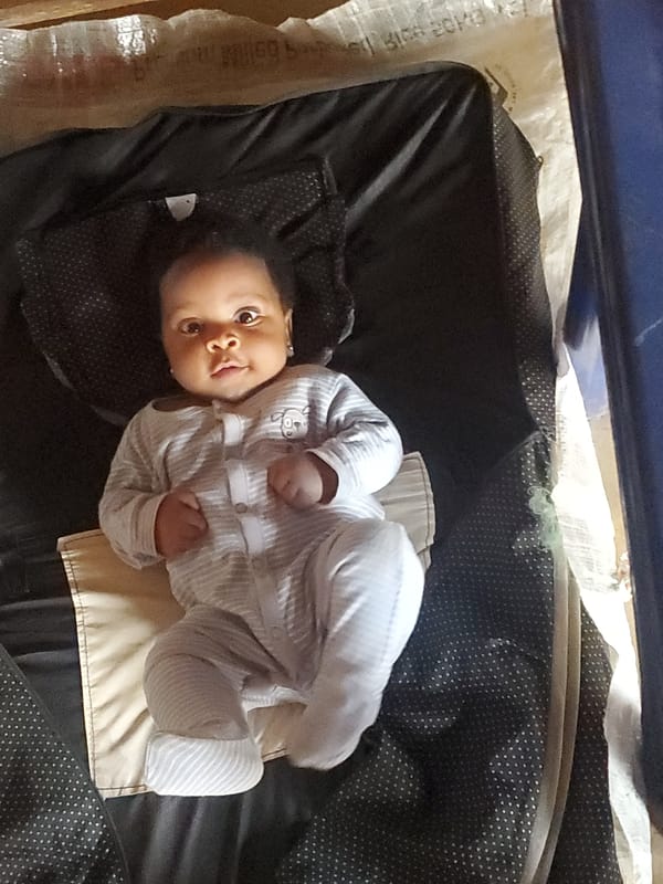 Baby in striped onesie observed in Ukwu-Abwa, Nigeria