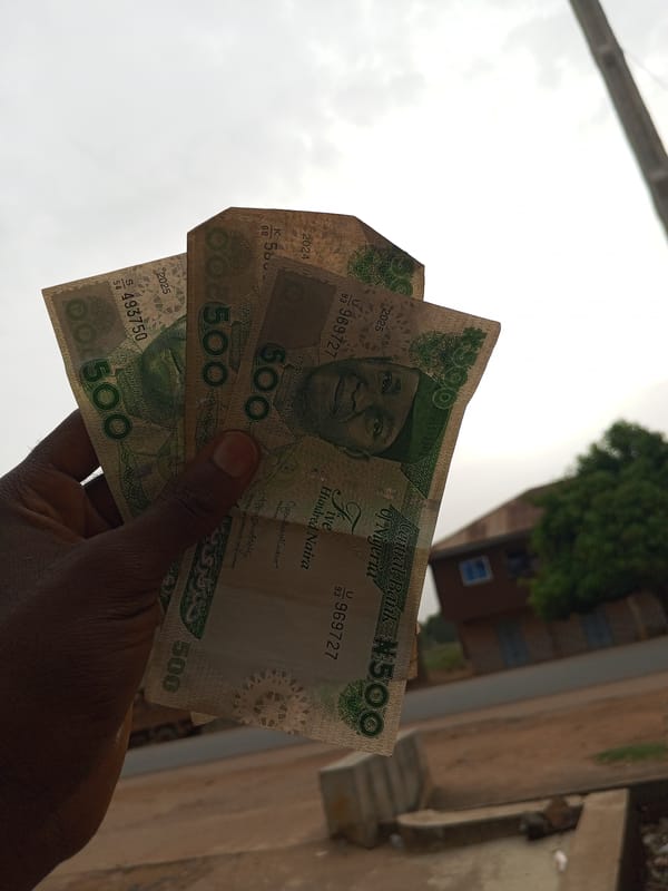 Person handles cash, wears Crocs in Durimi, Nigeria