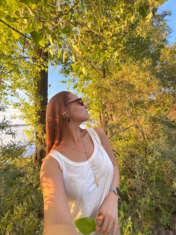 Woman enjoys golden hour at tranquil Russian lake