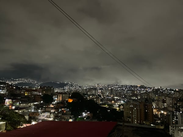 Nighttime religious procession with illuminated Jesus statue in Caracas