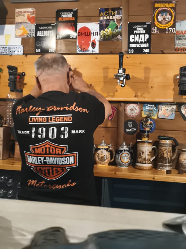 Afternoon gathering at motorcycle-themed bar in Sevastopol captured by patrons