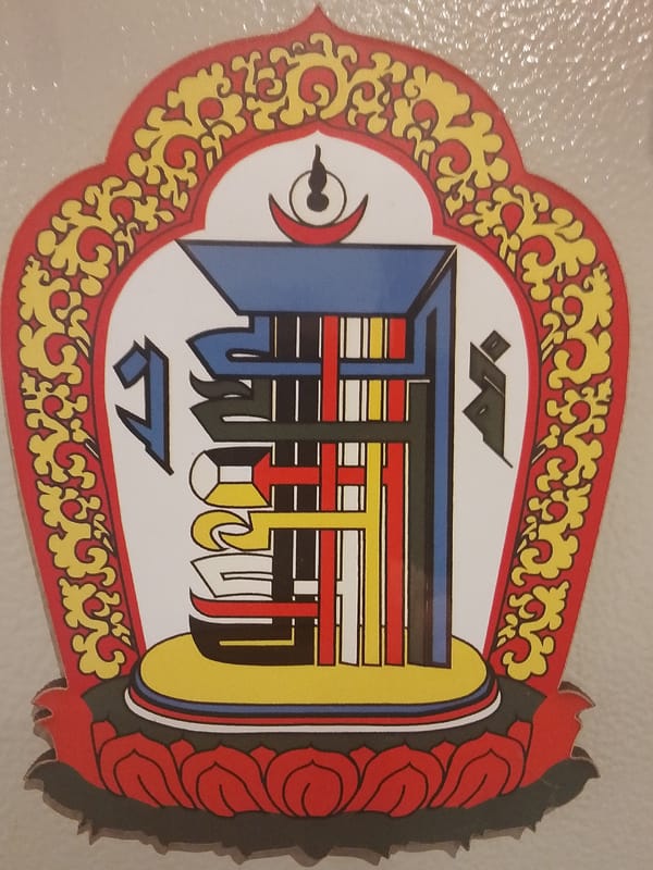 Decorative emblem with floral border observed in Go Maya