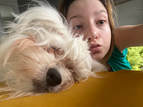 Woman takes selfies with white dog in Varna