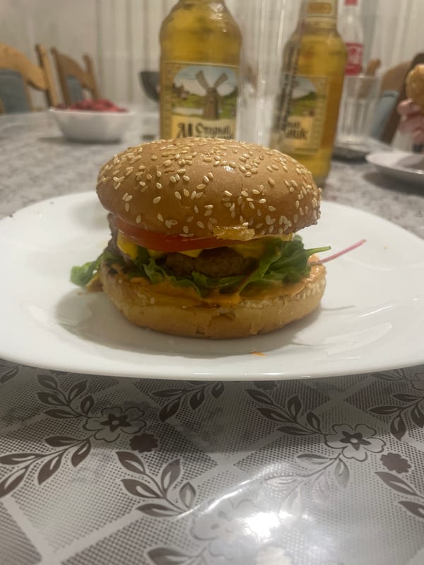 Homemade burgers and beers on a floral tablecloth