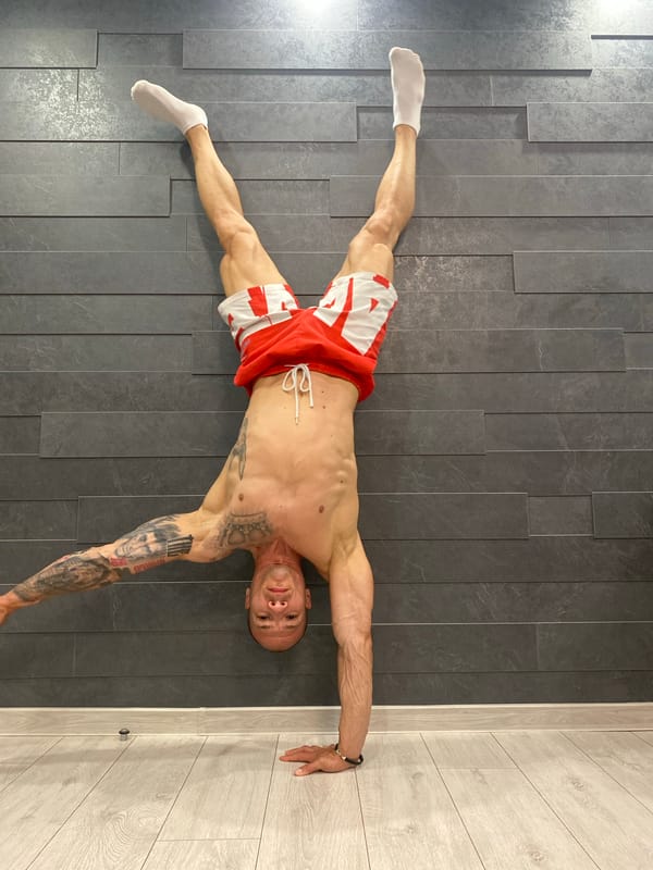 Man performs handstand against wall in Pleven, Bulgaria