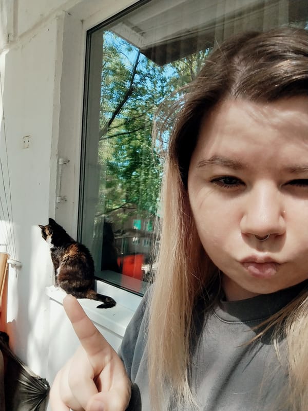 Woman Takes Morning Selfies With Cats on Apartment Balcony
