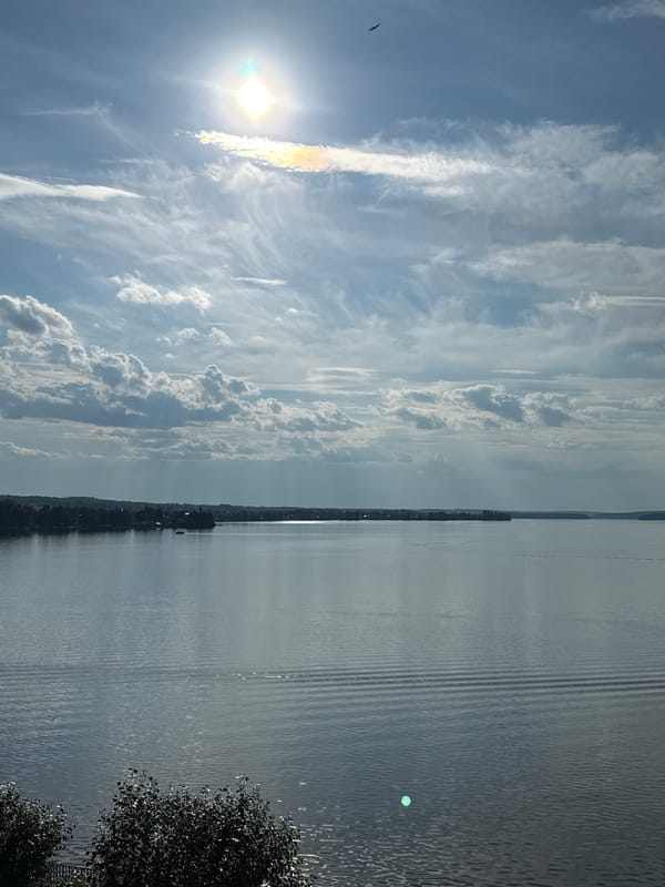 Still lake under a partly cloudy summer sky near Votkinsk